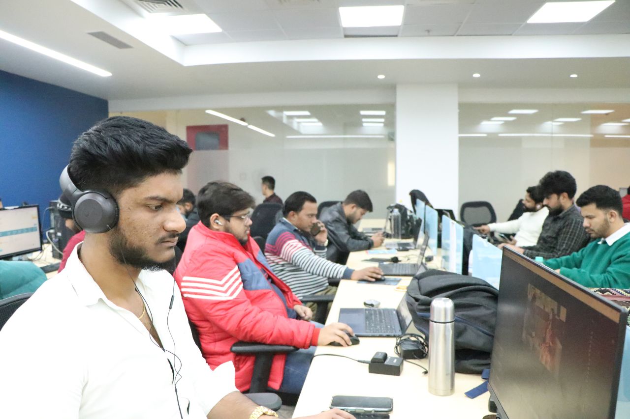 A row of colleagues working at their desks