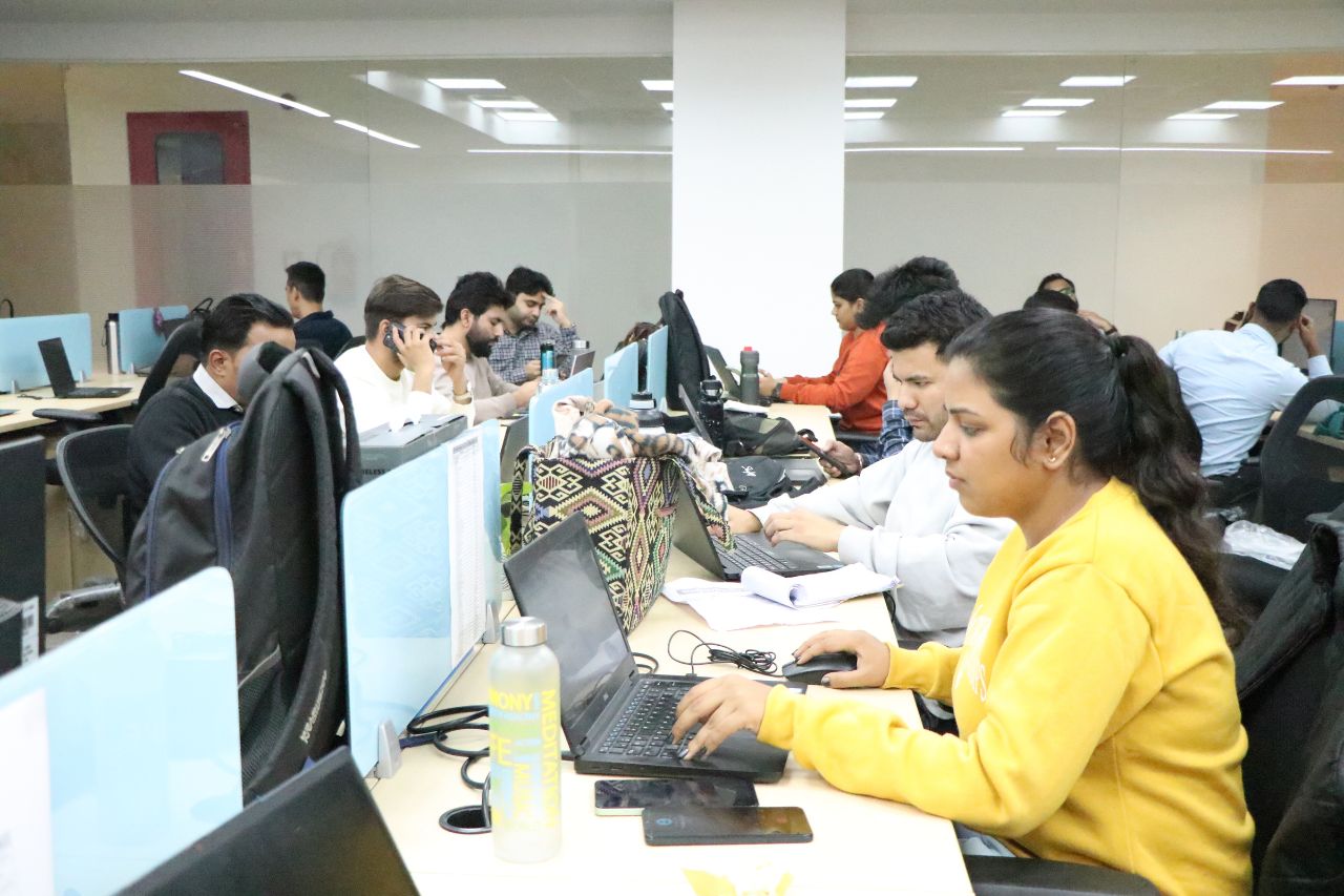 Colleagues working at shared desks on the office floor