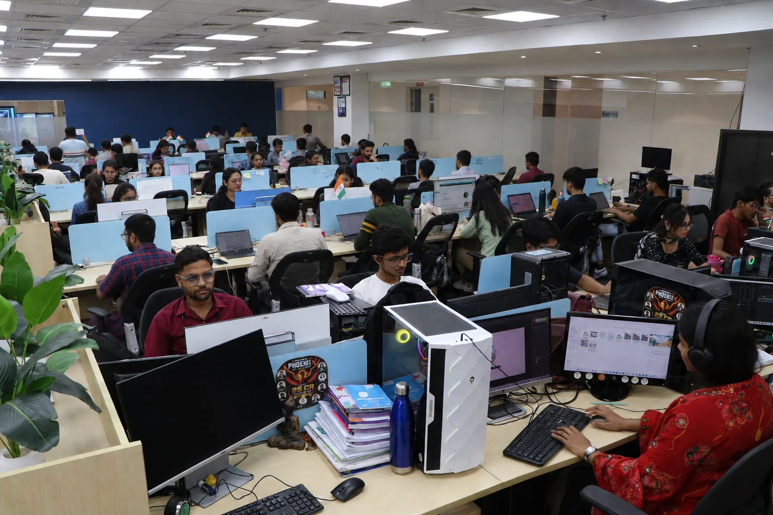 Rows of SNL team members at their desks in the open-plan development centre